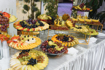 desserts with fruits, mousse, biscuits. Different types of sweet pastries, small colorful sweet cakes, macaron, and other desserts in the sweet buffet. candy bar for birthday