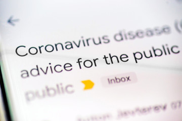coronavirus disease covid 19 email message on smart phone screen