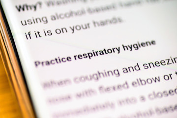 practice respiratory hygiene email message on smart phone screen
