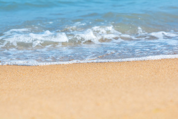 Blue sea wave on sandy beach. Travel background. Soft focus