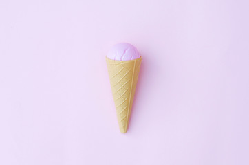 Toy ice cream cone on a pink background.