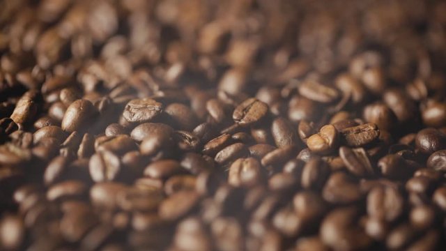 roasted coffee beans with smoke. turning around