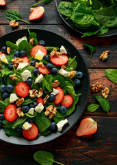 Spinach, Strawberry, blueberry salad with walnut and feta cheese. Summer healthy food