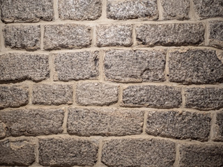 Old brick wall, old texture of gray stone blocks closeup