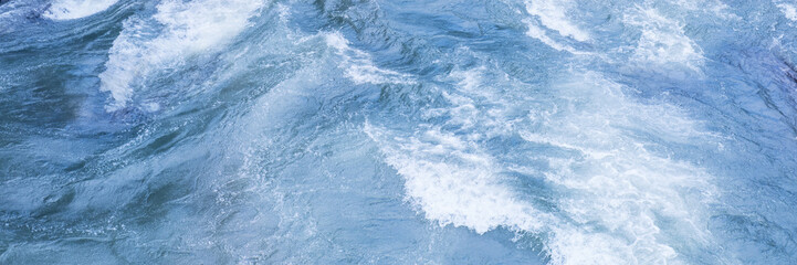 Fototapeta na wymiar Ocean water flow texture with waves and splashes with foam