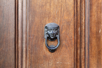 Old wooden brown door with metal door handle. Architectural textured background