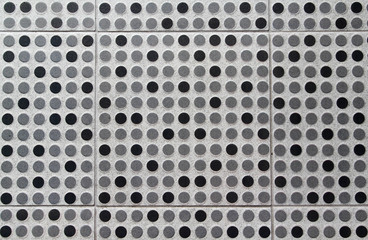 Polka dot black and grey floor tiles texture background.