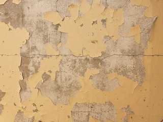 The ancient yellow background of natural cement or cracked surfaces from a long service life. Retro style wall