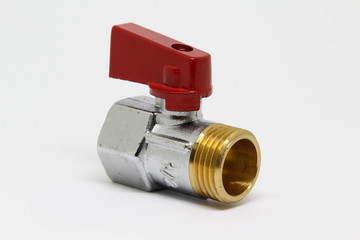 Brass ball valve with red handle on white background.