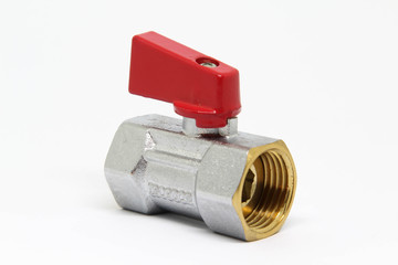 Brass ball valve with red handle on white background.