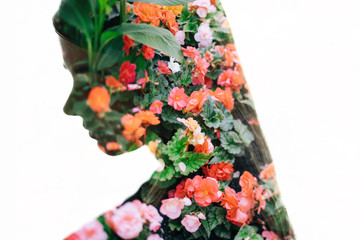  woman with long hair and blooming garden flowers