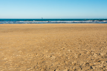 Valencia Beach (Malvarrosa) with waves and ships in the background