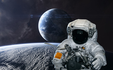 Astronaut on the background of planets in deep space. Science fiction. Elements of this image...