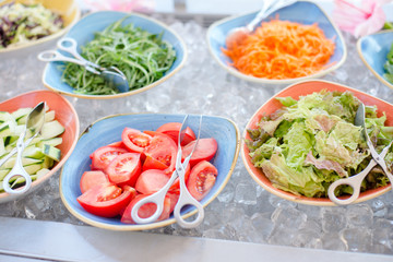 Close up of salad bar with assortment of ingredients