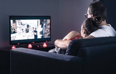 Couple watching movie or series. Online streaming and VOD service in tv screen. Film stream or...