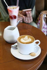 close up of late coffee and food on cafe table 