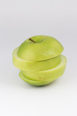 Top View and closed up isolate sliced green apple tower . Ripped healthy green fruit on white