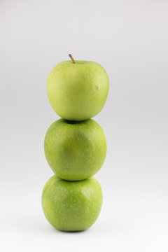 Closed up heathy green apples arranged by bottom tower.