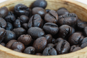 Roasted coffee beans  in  wood cup ,close up