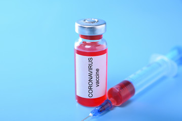 Coronavirus vaccine shot Covid 19 for baby vaccination on blue background, medicine and drug concept