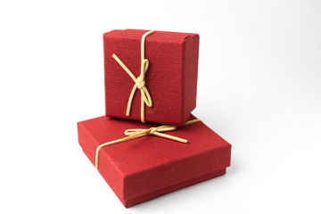 Surprise in flying boxes wrapped in red gift paper with bow on white background. Concept of holidays and greeting cards. Copy space.