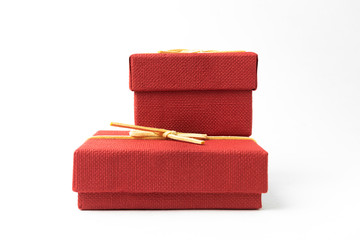 Surprise in flying boxes wrapped in red gift paper with bow on white background. Concept of holidays and greeting cards. Copy space.
