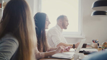 Happy European young CEO discussing international partnership with multiethnic colleagues at modern office meeting 4K.