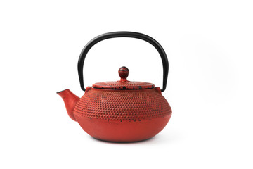 Red cast iron teapot on a white background. Asian culture.