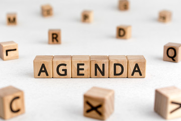 Agenda - words from wooden blocks with letters, a list of matters agenda concept, white background