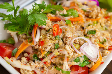 Close up texture of Glass Noodles Salad with Minced Pork. Thai cuisine.