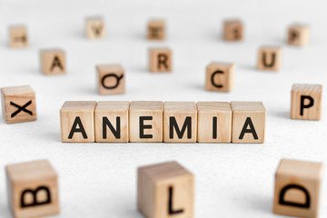 Anemia - words from wooden blocks with letters, a low number of red blood cells anemia concept,...