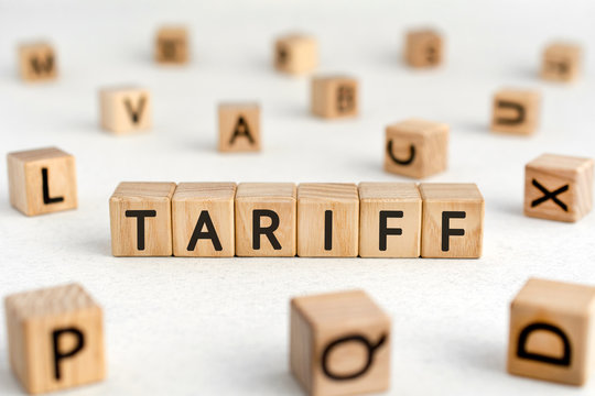 Tariff - words from wooden blocks with letters, a tax on imports or exports tariff concept, white background