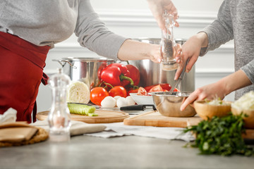 hands in the kitchen making dough on a wooden table. Free space for an advertising product