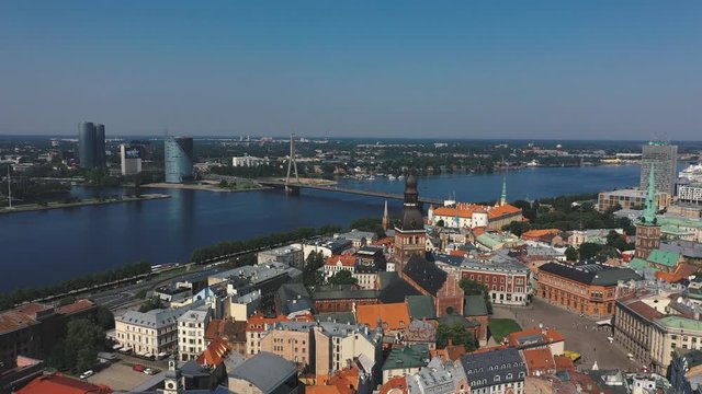 RIGA, LATVIA - MAY, 2019: Aerial drone view of the most famous spiers of the old city of Riga and the Daugava river.