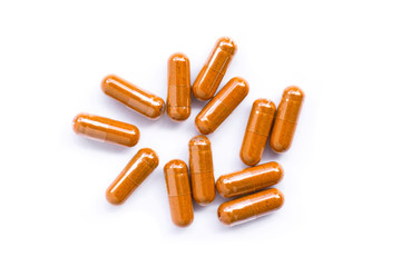 Turmeric capsules( known as curcumin, Curcuma , Tumeric) isolated on white background. Top view. Flat lay.