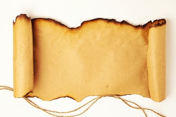 Scroll of old paper with burnt edges in a horizontal position with a rope on a white background