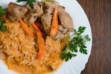 Fried cabbage in the white bowl on a rustic background