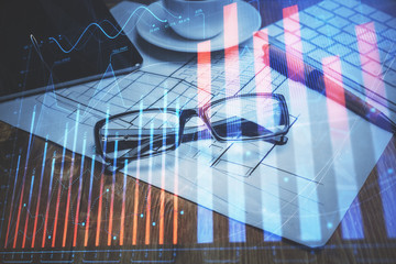 Financial chart hologram with glasses on the table background. Concept of business. Double exposure.