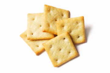 Crispy salty cracker on a white background. Flat lay food photography