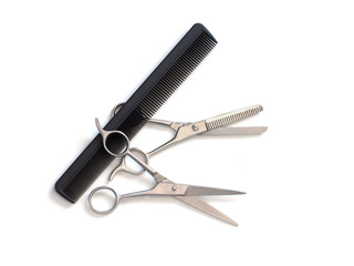 hairdresser professional scissors and black hairbrush comb isolated on white background close up