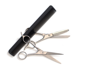 hairdresser professional scissors and black hairbrush comb isolated on white background close up