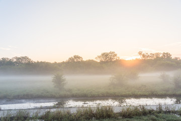 Fototapeta na wymiar Riverside nature park trail with foggy morning landscape near Dallas, Texas, USA