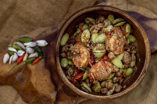 Stir Fried Bitter beans (Sator) with Shrimp in wooden bowl, It is a traditional food of southern Thailand, Spicy, stink bean.