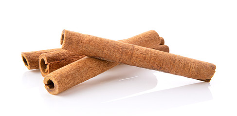  cinnamon sticks stacked on white background