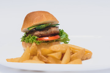 tasty hamburger, French fries and chili sauce on white plate, Fast food with copy space