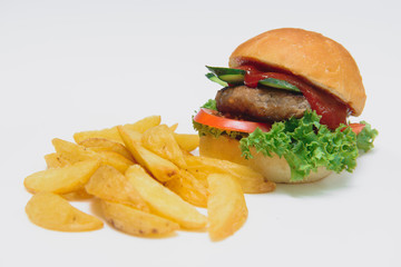 tasty hamburger, French fries and chili sauce on white plate, Fast food with copy space