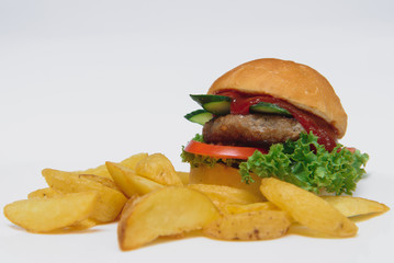tasty hamburger, French fries and chili sauce on white plate, Fast food with copy space
