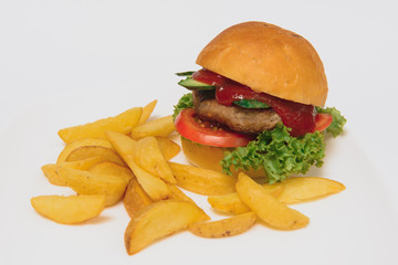 tasty hamburger, French fries and chili sauce on white plate, Fast food with copy space