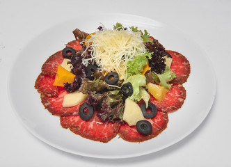 Fresh salad with vegetables and cheese on a white background