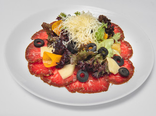 Fresh salad with vegetables and cheese on a white background